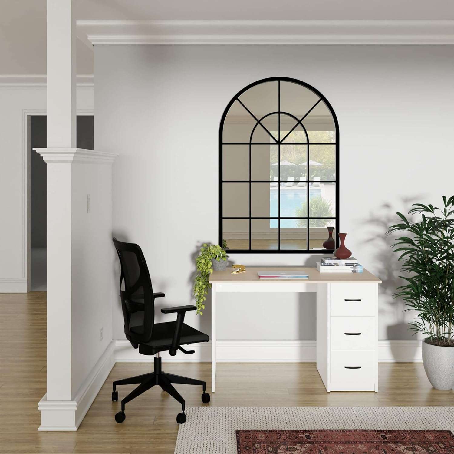 Modern Aure Desk in oak and white finish with drawers, styled in a minimalist home office setting with black ergonomic chair and decorative mirror.