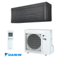 Daikin Stylish FTXA20BT inverter air conditioner with black wood indoor unit, white outdoor unit, remote control, 7,000 BTU capacity, Wi-Fi control, Coanda Effect, and energy-efficient R-32 refrigerant