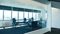 Bosch Climate 5000i M indoor console air conditioner unit in modern office meeting room with glass walls and chairs