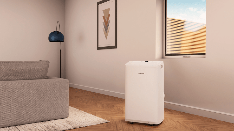 Bosch Cool 2000 mobile air conditioner with 2,000W cooling capacity in a modern living room setting