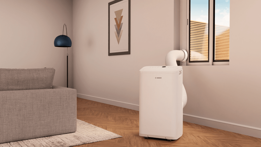 Bosch Cool 2000 mobile air conditioner in a living room with exhaust hose connected to window for efficient portable cooling.