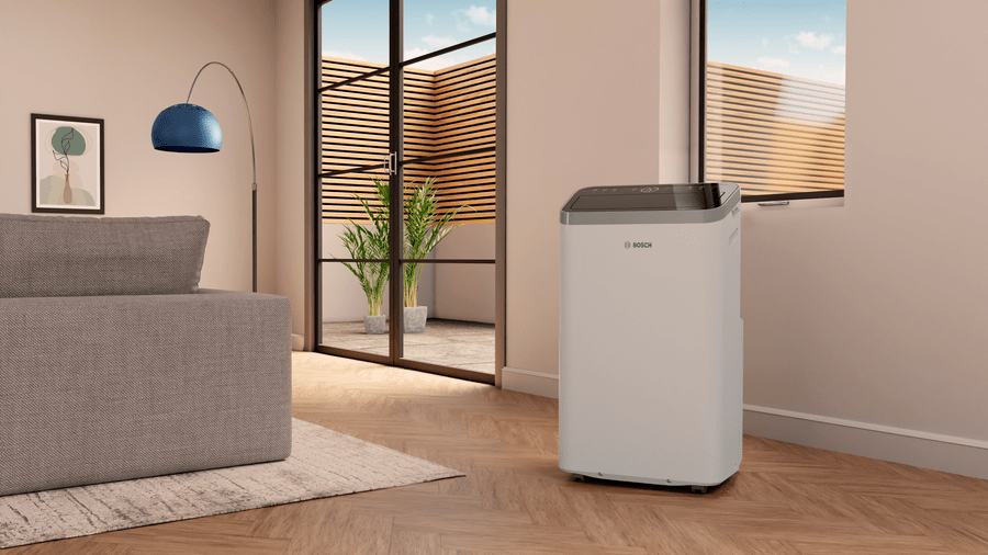 Bosch Cool 4000 mobile air conditioner in modern living room near window with patio view