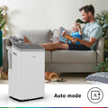 Bosch Cool 5000 mobile air conditioner in a living room with a man and child, showcasing auto mode and sleek, compact design.