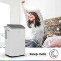 Bosch Cool 5000 mobile air conditioner in modern room with woman stretching, featuring sleep mode and inverter technology for energy-efficient cooling.